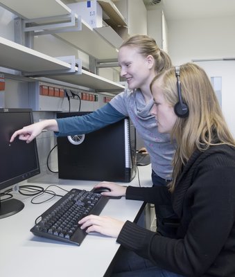 Wissenschaftlerin erklärt Probandin Tests, die sie am Computer machen soll